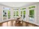Bright breakfast nook featuring a round table with large windows and a door to the deck at 3851 Glenhurst Se Dr, Smyrna, GA 30080