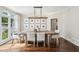 Charming dining room with ample natural light, stylish chandelier and seating for six at 3851 Glenhurst Se Dr, Smyrna, GA 30080