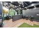 Finished basement bar with seating, modern lighting, and golf simulator at 3851 Glenhurst Se Dr, Smyrna, GA 30080