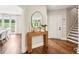 Elegant foyer with hardwood floors, a rustic console table, and a view into the dining room at 3851 Glenhurst Se Dr, Smyrna, GA 30080