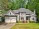 Charming home with a well-manicured lawn, mature trees, and a two-car garage at 3851 Glenhurst Se Dr, Smyrna, GA 30080