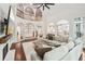 Open-concept living room with fireplace, hardwood floors, and natural light at 3851 Glenhurst Se Dr, Smyrna, GA 30080