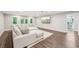 Spacious living room with wood floors, modern sofa, and doorway to an en suite bathroom at 3851 Glenhurst Se Dr, Smyrna, GA 30080