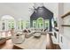 Open-concept living room with vaulted ceilings, a fireplace, and large windows at 3851 Glenhurst Se Dr, Smyrna, GA 30080