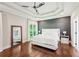 Spacious main bedroom with tray ceiling, dark accent wall, and large window at 3851 Glenhurst Se Dr, Smyrna, GA 30080