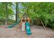A wooden backyard playground, with slides, a climbing wall, and swings, offers outdoor fun for the Gathering at 3851 Glenhurst Se Dr, Smyrna, GA 30080