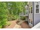 View of the backyard and a multi-level deck, nestled among the lush greenery and foliage at 3851 Glenhurst Se Dr, Smyrna, GA 30080