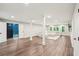 Large recreation room with sectional sofa, white columns, a TV, and easy access to the backyard through the doors at 3851 Glenhurst Se Dr, Smyrna, GA 30080