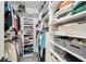 Organized walk-in closet with custom shelving, ample storage, and neatly arranged clothing at 3851 Glenhurst Se Dr, Smyrna, GA 30080