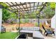Charming backyard with a covered pergola, lush greenery, and comfortable outdoor seating at 51 Norton Ave, Acworth, GA 30101