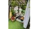 Outdoor living space featuring seating, lush plants, and shaded pergola at 51 Norton Ave, Acworth, GA 30101