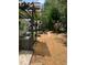 Backyard view featuring an outdoor seating area, stone pathway, and mature trees at 51 Norton Ave, Acworth, GA 30101