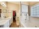 Bright bathroom boasts double sinks, a soaking tub, and a walk-in closet for optimal storage at 51 Norton Ave, Acworth, GA 30101