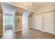 Sunlit bedroom with hardwood floors, patterned wallpaper, and two doors at 51 Norton Ave, Acworth, GA 30101