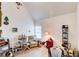 A bright, disorganized room with a high ceiling, featuring a recliner, natural light and a guitar at 51 Norton Ave, Acworth, GA 30101