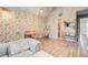 Spacious living area featuring unique wallpaper, vaulted ceilings, and wood-style flooring at 51 Norton Ave, Acworth, GA 30101