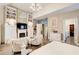 Primary bedroom features hardwood flooring, a chandelier, fireplace, and open access to the primary bath and closet at 51 Norton Ave, Acworth, GA 30101