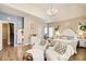 This luxurious bedroom features elegant decor, neutral coloring, a chandelier, and lots of seating at 51 Norton Ave, Acworth, GA 30101