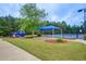 Community tennis court and playground shaded by mature trees, offering recreational activities at 51 Norton Ave, Acworth, GA 30101