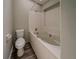 Bathroom features a tub and toilet, neutral walls and modern dark flooring at 6351 Stablewood Way, Lithonia, GA 30058