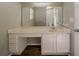 Bathroom with a large mirror, spacious vanity with sink, drawers, and cabinet at 6351 Stablewood Way, Lithonia, GA 30058