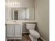 Bathroom showing a toilet, sink, and a mirror at 6351 Stablewood Way, Lithonia, GA 30058