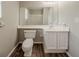 Bathroom featuring a white vanity, a large mirror, and wood-look flooring at 6351 Stablewood Way, Lithonia, GA 30058