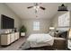 Bright bedroom featuring a ceiling fan, flat screen tv and stylish décor at 6351 Stablewood Way, Lithonia, GA 30058