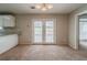 Open dining room with french doors leading to the exterior, neutral walls, and carpeted floors at 6351 Stablewood Way, Lithonia, GA 30058