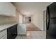 Open kitchen with tile flooring, granite counters and an adjacent living area with a stone fireplace at 6351 Stablewood Way, Lithonia, GA 30058
