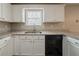 Kitchen with white cabinetry, granite countertops, stainless steel sink and dishwasher at 6351 Stablewood Way, Lithonia, GA 30058