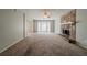 Spacious living room with a stone fireplace and a view to a sunny bay window at 6351 Stablewood Way, Lithonia, GA 30058