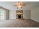 Spacious living room featuring stone fireplace, ceiling fan and a window view at 6351 Stablewood Way, Lithonia, GA 30058