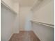 Walk-in closet with open shelving and neutral colored walls and carpeting at 6351 Stablewood Way, Lithonia, GA 30058