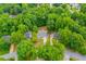 Aerial perspective of the home nestled among mature trees in a serene neighborhood at 9691 Squirrel Wood Run, Douglasville, GA 30135