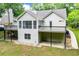 Rear exterior view of the home showcasing the spacious deck and sunroom overlooking the backyard at 9691 Squirrel Wood Run, Douglasville, GA 30135