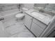 A bathroom featuring a tub, toilet, granite vanity, and a marble floor at 9691 Squirrel Wood Run, Douglasville, GA 30135