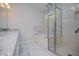 A bathroom featuring a marble floor, a soaking tub, and a large glass shower at 9691 Squirrel Wood Run, Douglasville, GA 30135