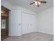 A bedroom featuring neutral carpet, a ceiling fan, and a closet with bi-fold doors at 9691 Squirrel Wood Run, Douglasville, GA 30135
