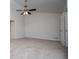 Spacious bedroom with neutral carpet, vaulted ceilings, a ceiling fan, and closet access at 9691 Squirrel Wood Run, Douglasville, GA 30135