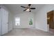 Primary bedroom with vaulted ceiling, ceiling fan, neutral carpet and access to primary bathroom at 9691 Squirrel Wood Run, Douglasville, GA 30135