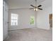 Spacious bedroom with a vaulted ceiling, neutral carpet, two windows, and closet access at 9691 Squirrel Wood Run, Douglasville, GA 30135