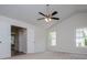 Vaulted main bedroom with ceiling fan, neutral carpet, two windows and access to main bath and closets at 9691 Squirrel Wood Run, Douglasville, GA 30135