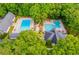 Aerial view of two community pools with ample seating and lounging areas surrounded by trees at 9691 Squirrel Wood Run, Douglasville, GA 30135