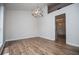 Bright dining room featuring wood floors and a modern chandelier for elegant dining at 9691 Squirrel Wood Run, Douglasville, GA 30135