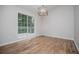 Dining room features hardwood floors, a modern chandelier, and sliding glass doors to an outdoor deck at 9691 Squirrel Wood Run, Douglasville, GA 30135