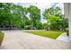 View of a tree-lined street from the home's driveway, showcasing curb appeal and neighborhood charm at 9691 Squirrel Wood Run, Douglasville, GA 30135