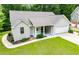Charming single-story home featuring an attached garage, landscaped yard, and covered entry at 9691 Squirrel Wood Run, Douglasville, GA 30135