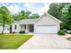 Charming single-story home featuring an attached garage, manicured lawn, and inviting curb appeal at 9691 Squirrel Wood Run, Douglasville, GA 30135