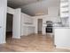 Modern kitchen featuring stainless steel appliances, granite countertops, and wood-look flooring at 9691 Squirrel Wood Run, Douglasville, GA 30135